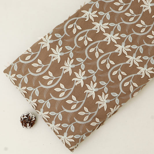 Fabric with floral pattern on a brown background