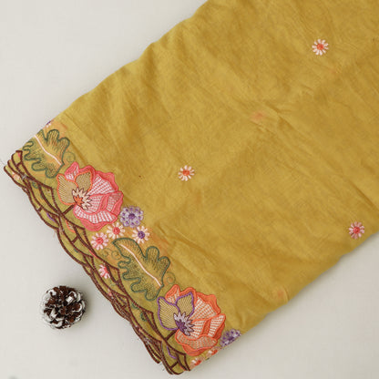 Mustard yellow fabric with floral embroidery on a white background