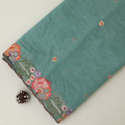 Teal fabric with floral embroidery on a white background