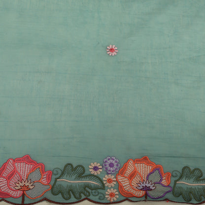 Teal fabric with floral embroidery at the bottom