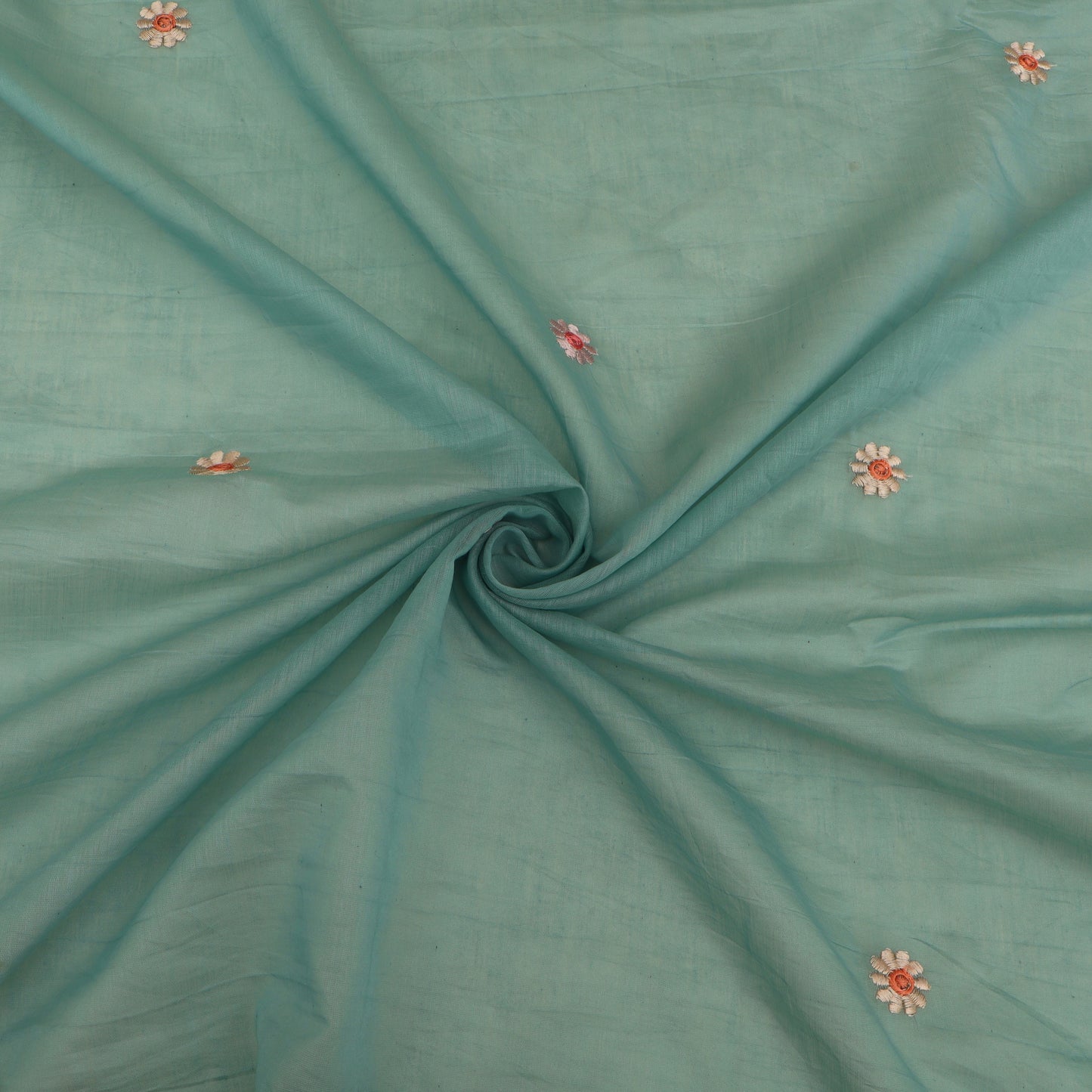 Teal fabric with small floral embellishments
