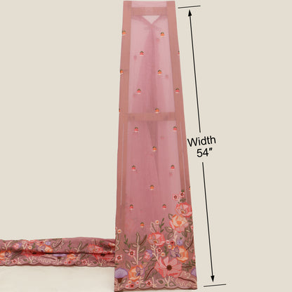 Pink embroidered fabric with floral patterns and a measurement label on a beige background