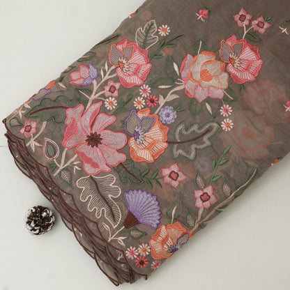 Embroidered floral fabric with colorful flowers on a plain background