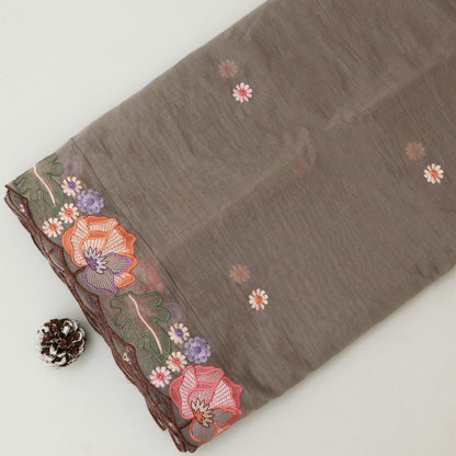Brown fabric with floral embroidery on a white background