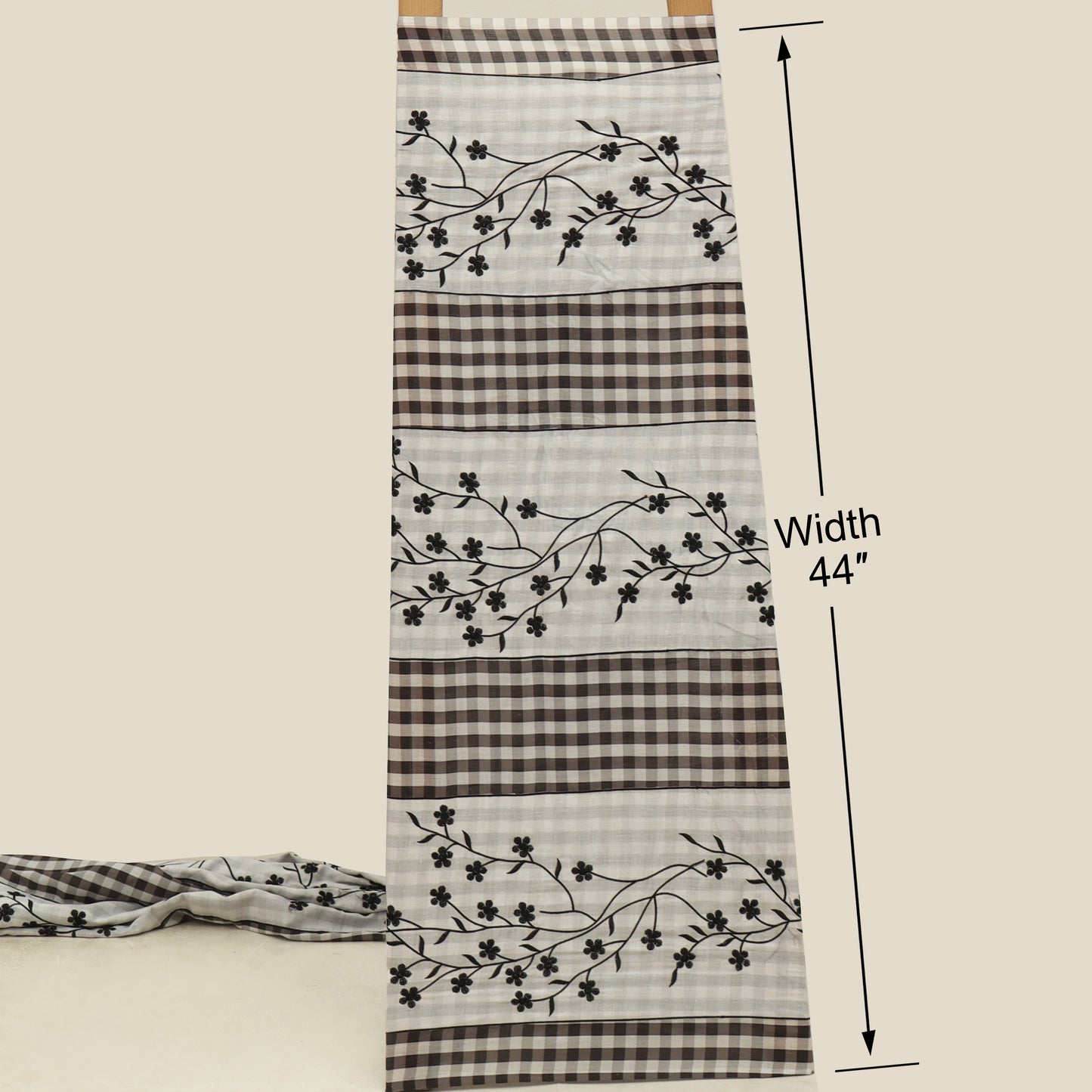 Fabric with floral pattern and checkered design, displayed on a white background with measurements.