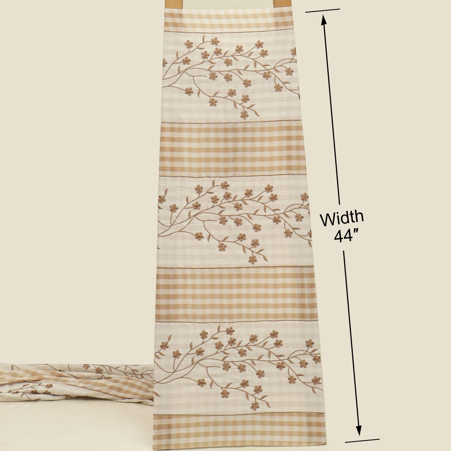 Fabric with floral patterns and checkered design, shown with a measurement label indicating width 44 inches.