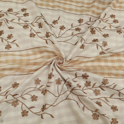 Fabric with brown floral embroidery on a beige and brown checkered background