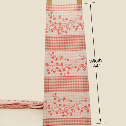 Fabric with red checkered and floral patterns on a beige background, showing width measurement.