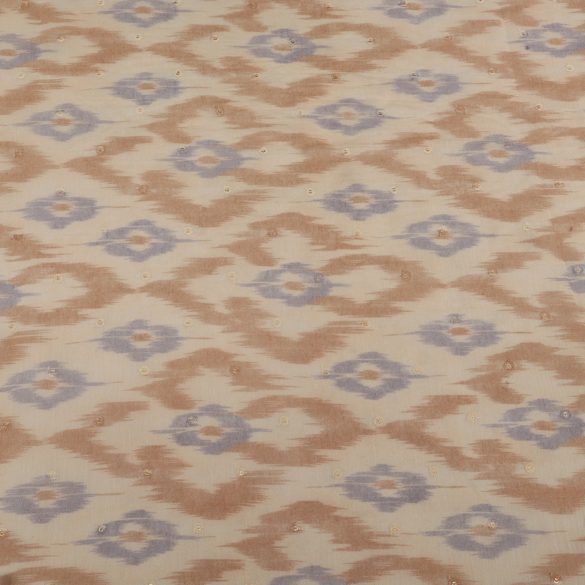 Patterned fabric with brown and blue geometric design on a beige background