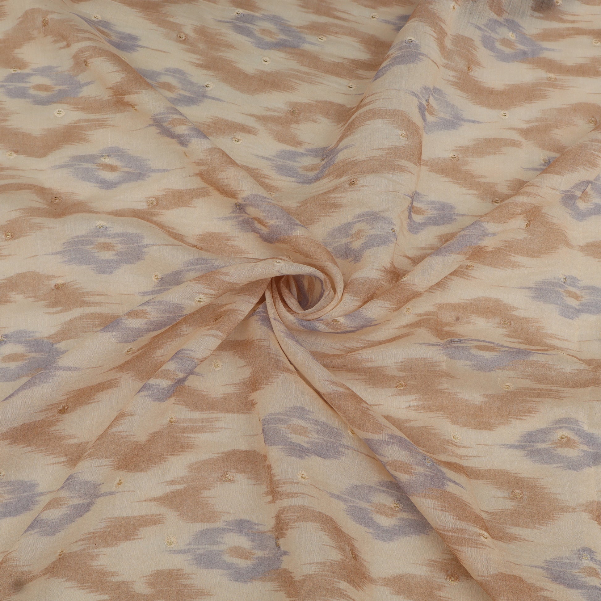 Fabric with a pattern of interlocking shapes in brown and blue on a beige background