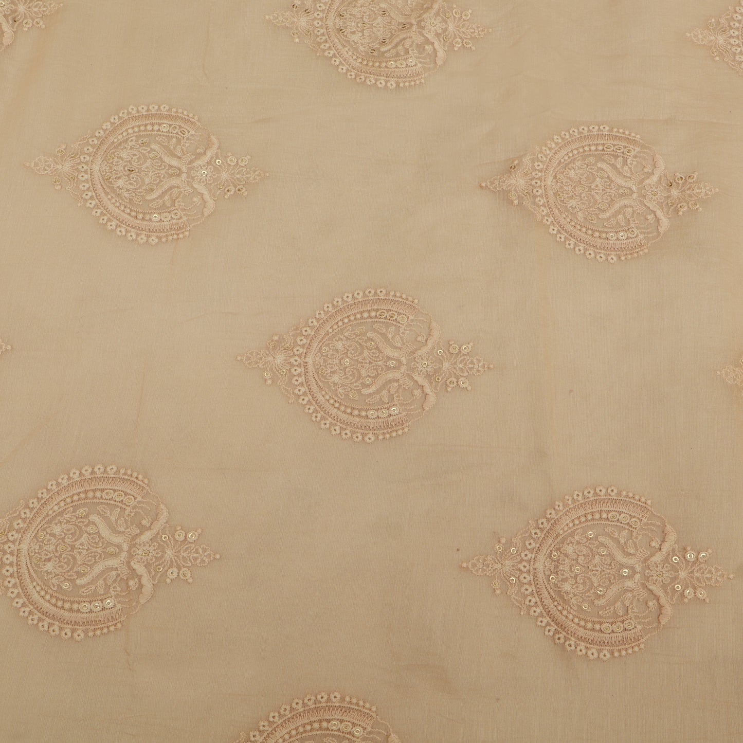 Decorative beige fabric with intricate gold patterns