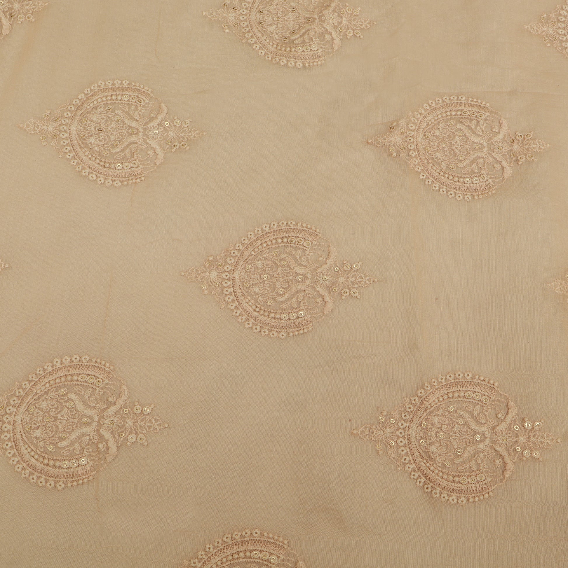 Decorative beige fabric with intricate gold patterns
