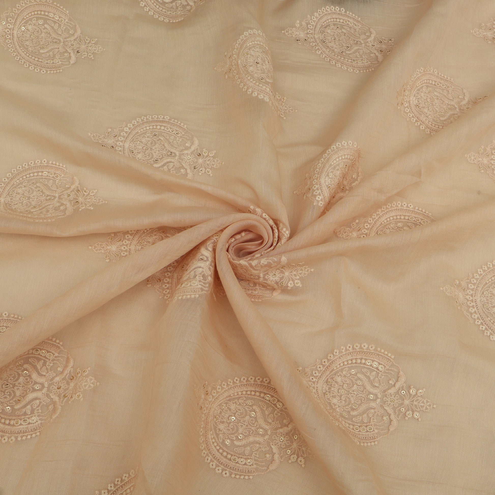 Beige fabric with intricate gold embroidery in a spiral pattern