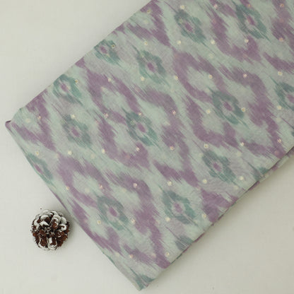 Fabric with a purple and green pattern on a white background