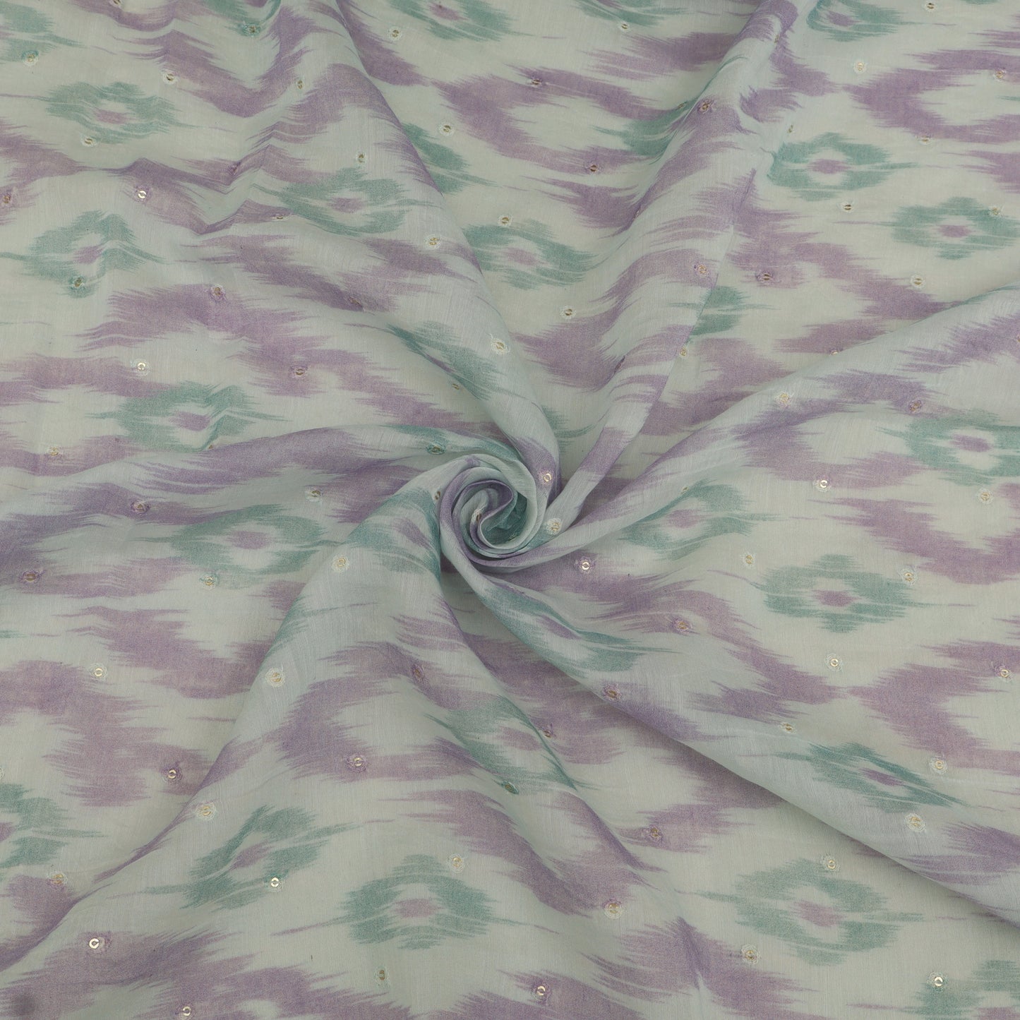 Fabric with a pattern of wavy lines in green and purple