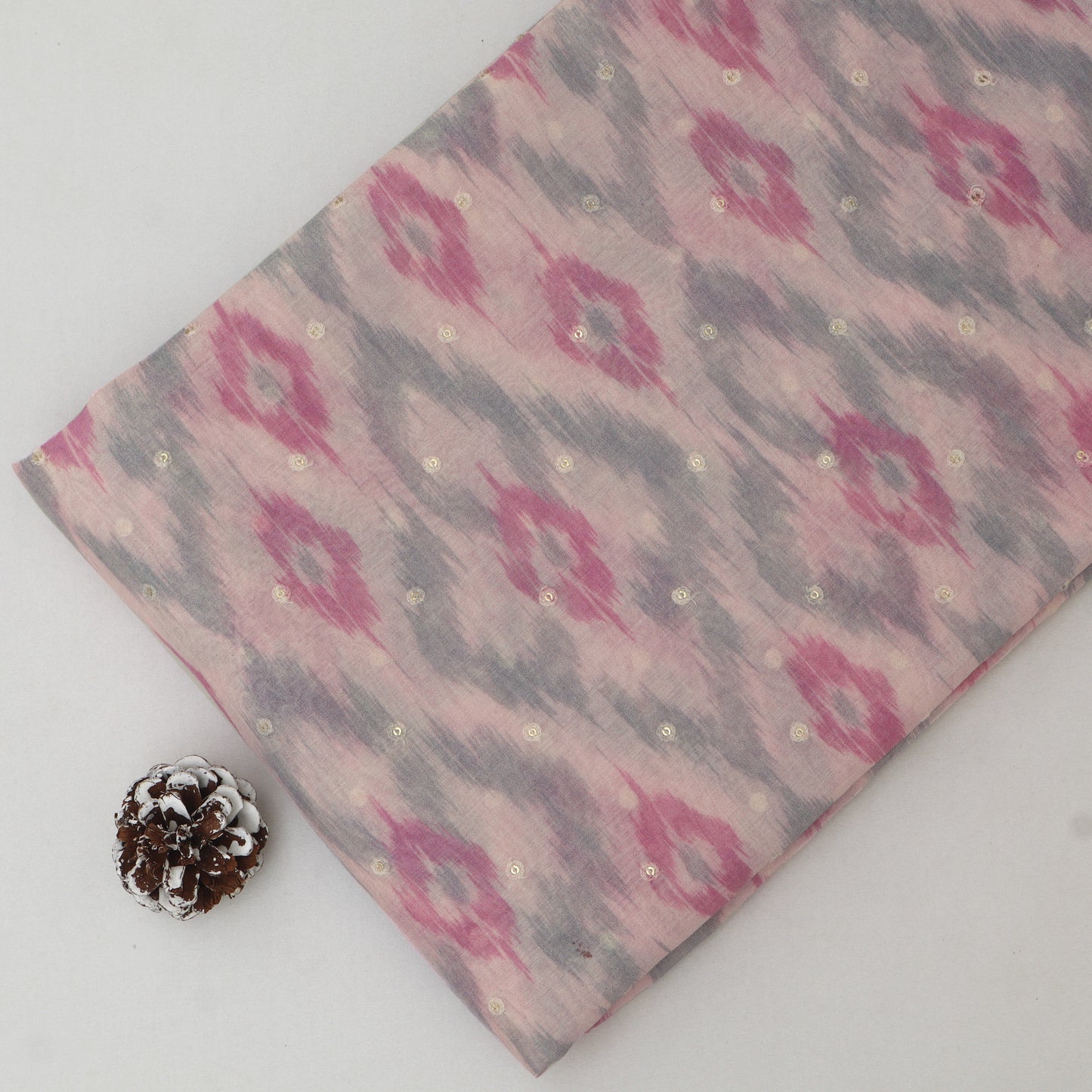 Fabric with a pink and gray pattern on a white background