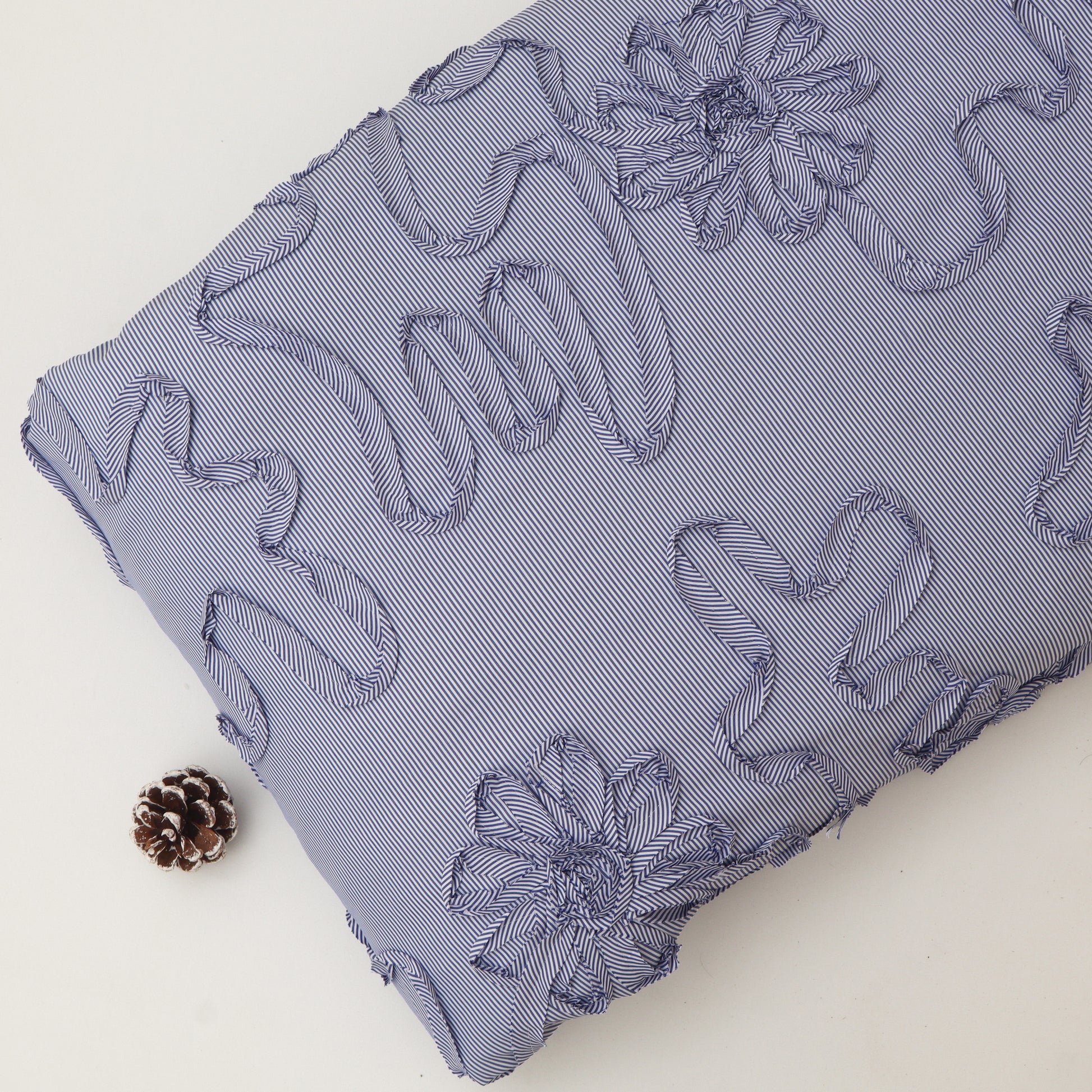 Blue textured fabric with floral patterns on a white background