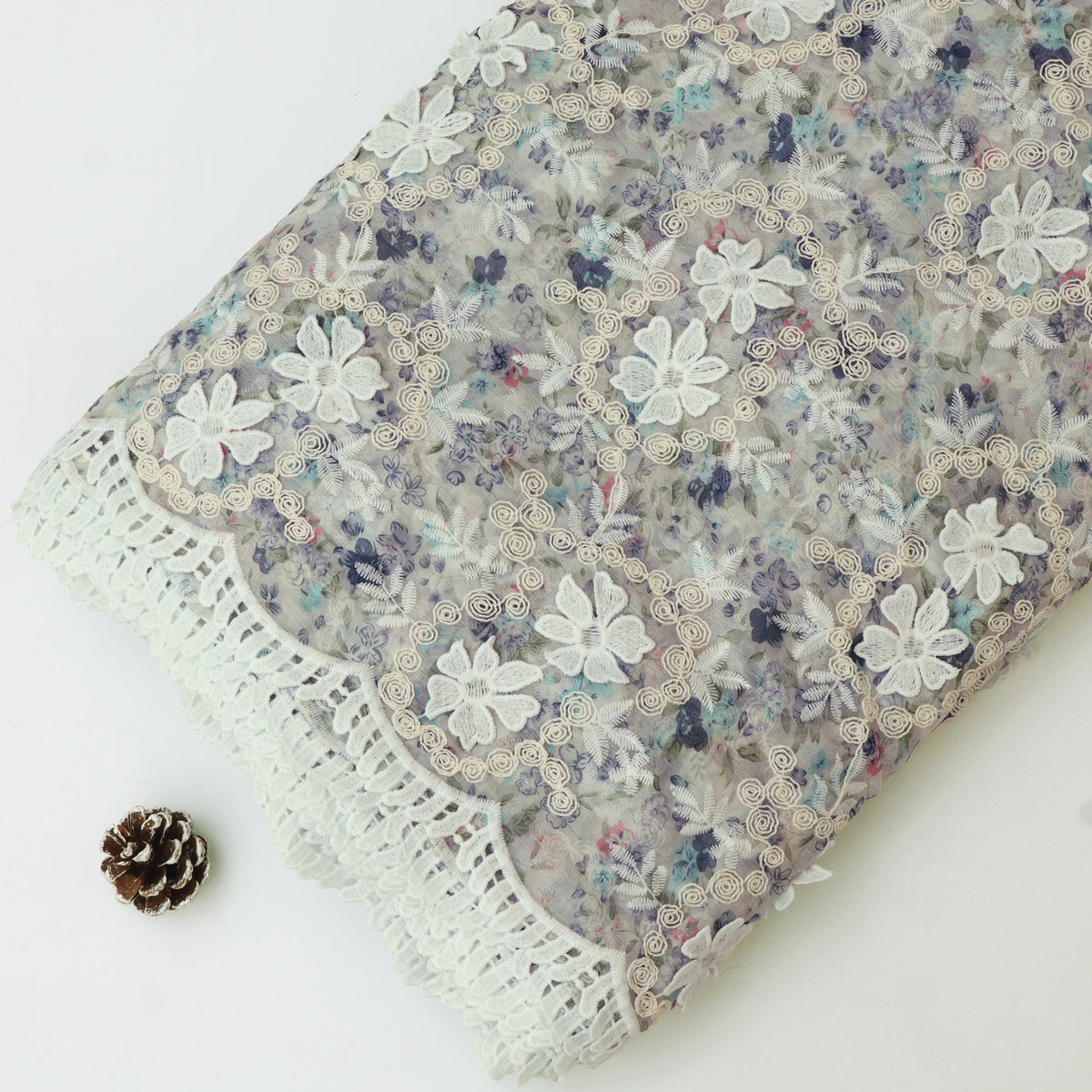 Floral fabric with lace trim on a white background