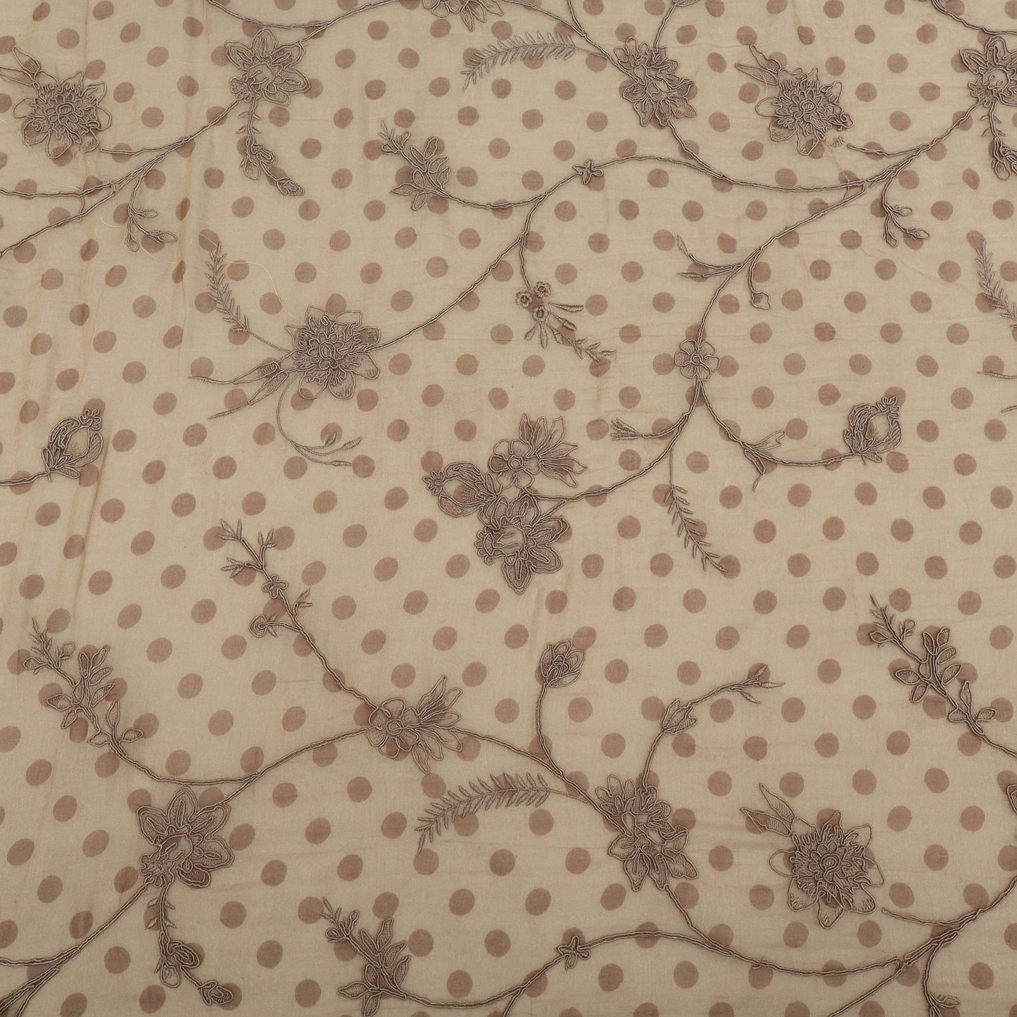 Textile pattern with brown polka dots and floral designs on a beige background