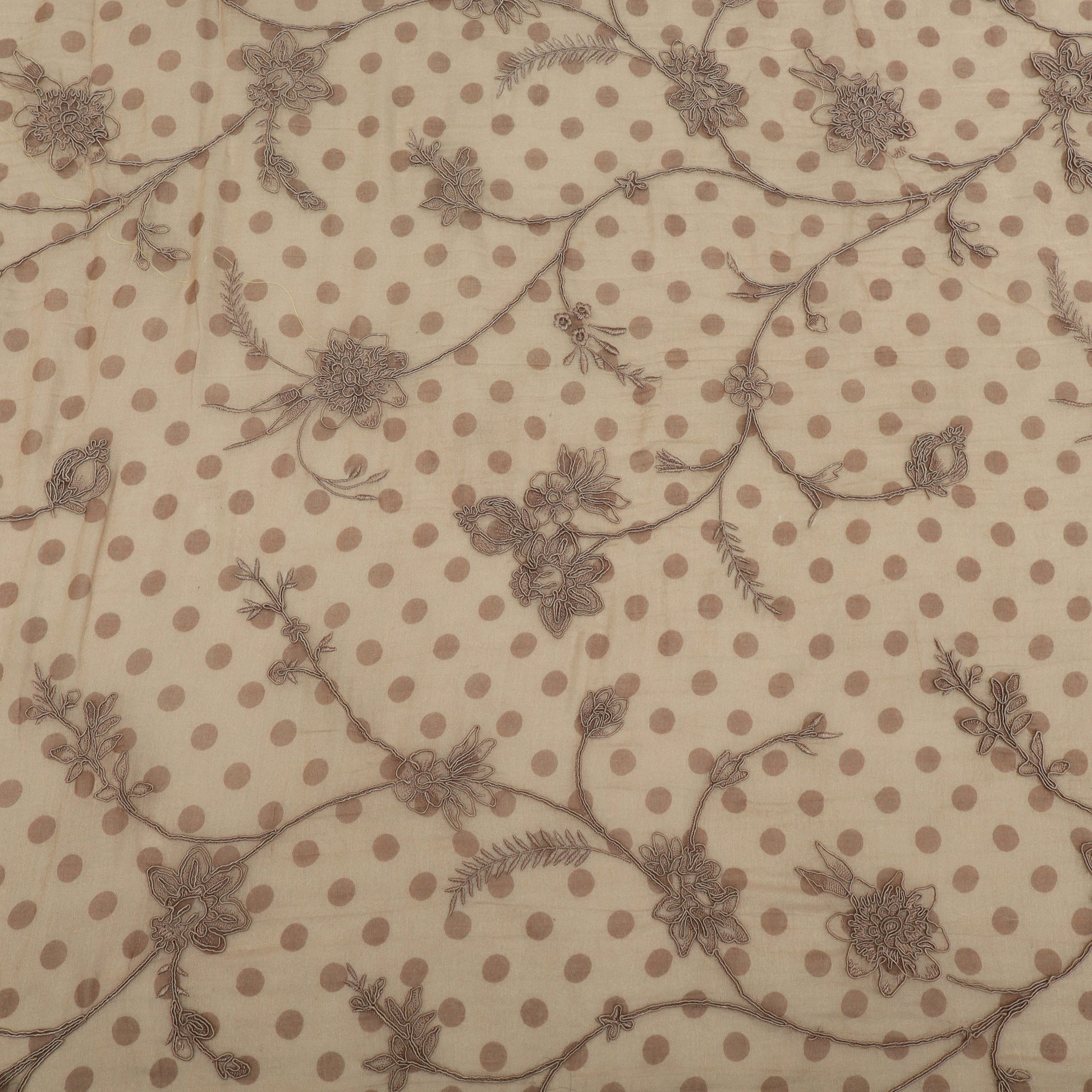 Textile pattern with brown polka dots and floral designs on a beige background
