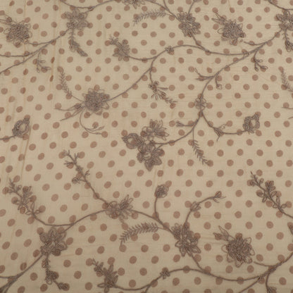 Textile pattern with brown polka dots and floral designs on a beige background