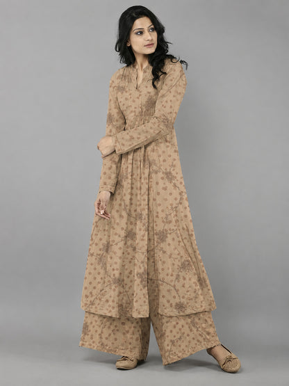 Woman wearing a beige traditional outfit with a plain background