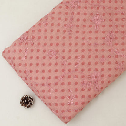 Pink polka dot fabric with floral patterns on a white background
