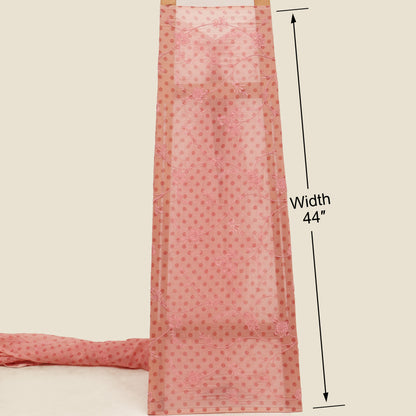 Pink fabric with measurement label on a beige background