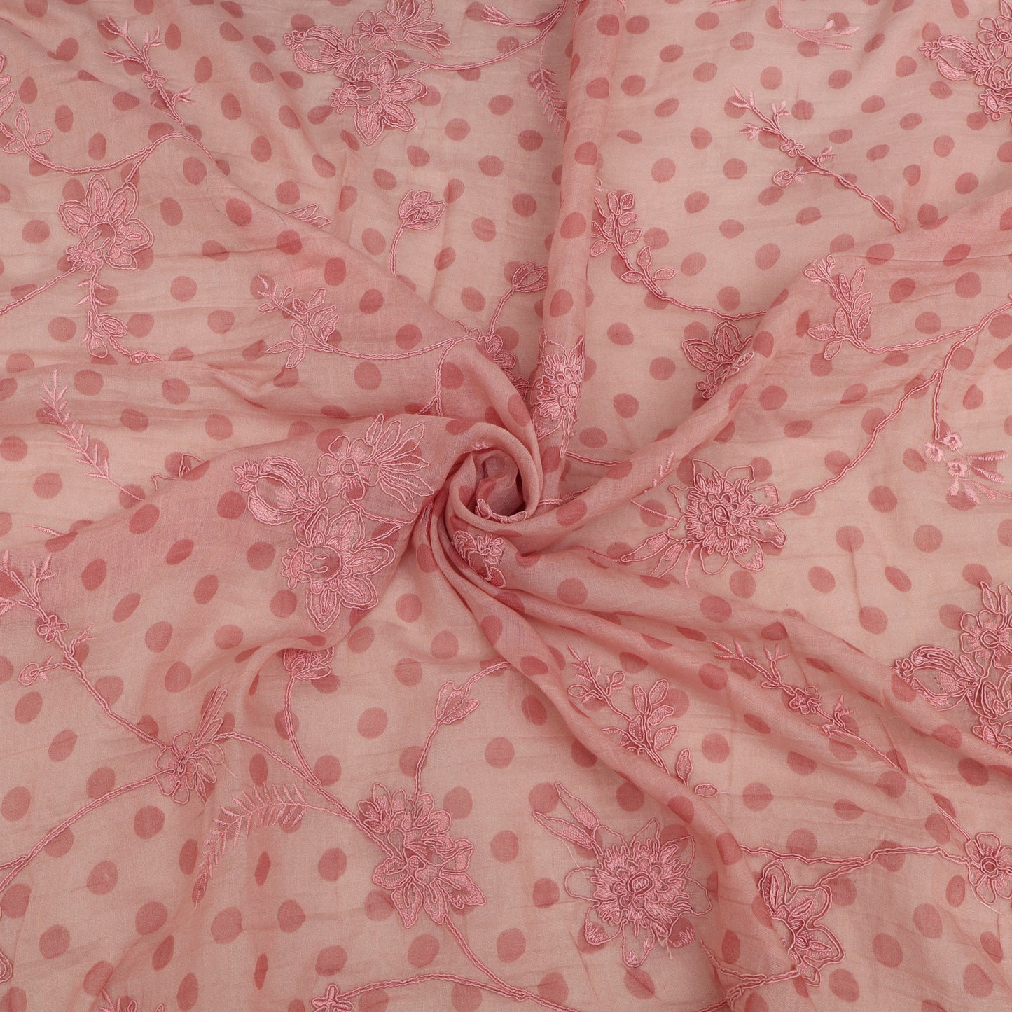 Pink fabric with floral patterns and polka dots