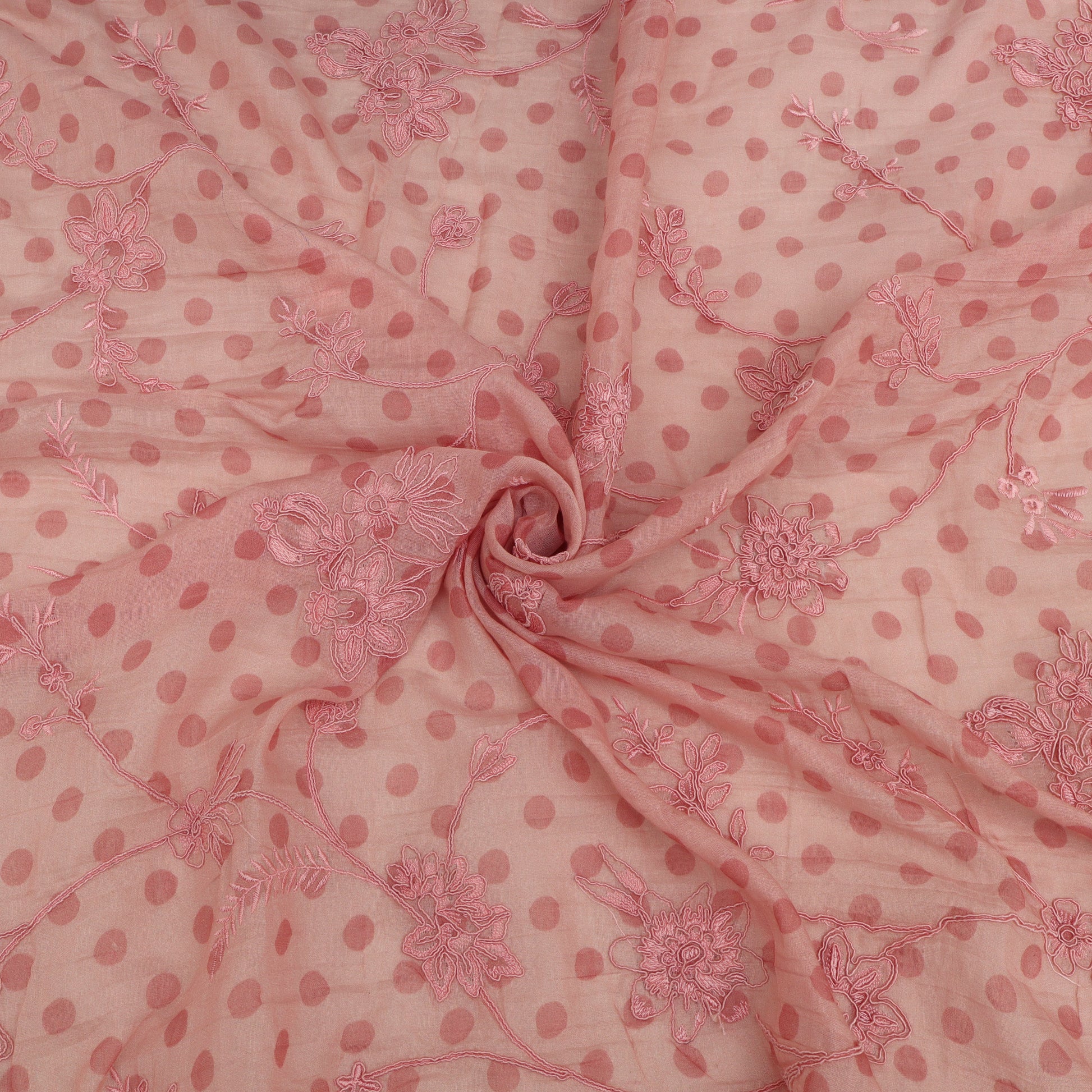 Pink fabric with floral patterns and polka dots