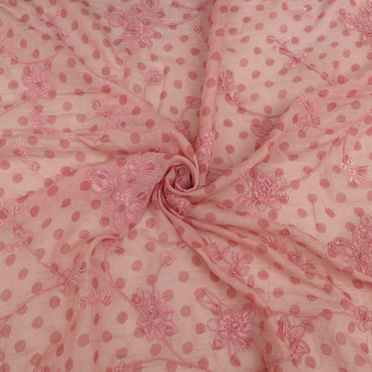 Pink fabric with floral patterns and polka dots