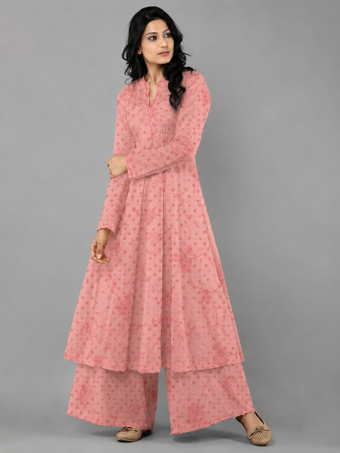 Woman wearing a pink traditional outfit with a gray background