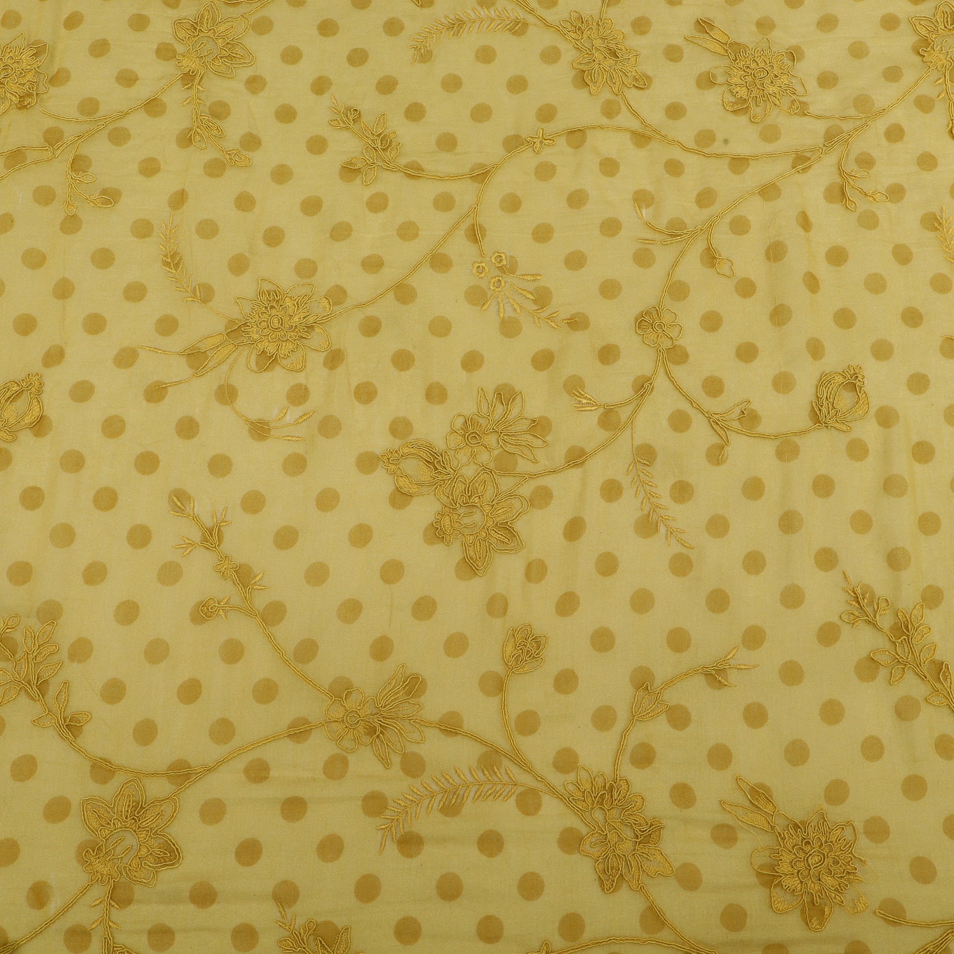 Yellow fabric with gold polka dots and floral patterns
