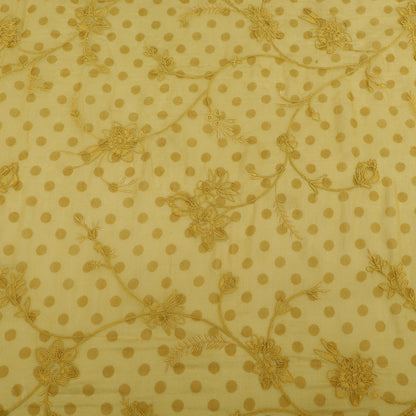 Yellow fabric with gold polka dots and floral patterns