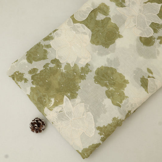 Floral-patterned fabric with green and white flowers on a plain background